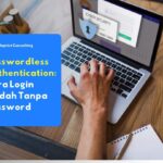 Seorang karyawan yang sedang login ke portal perusahaan menggunakan sensor sidik jari di laptopnya sebagai bentuk implementasi passwordless authentication yang aman dan praktis.