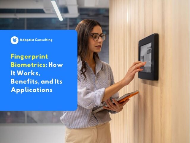 A female professional using a fingerprint biometrics access panel on a wall in a modern office environment.