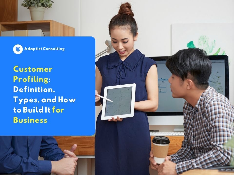 Business team discussing customer profiling strategy using a tablet and analytics data in the office.