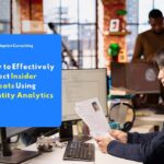 IT staff reviewing identity documents to detect insider threats using analytics.