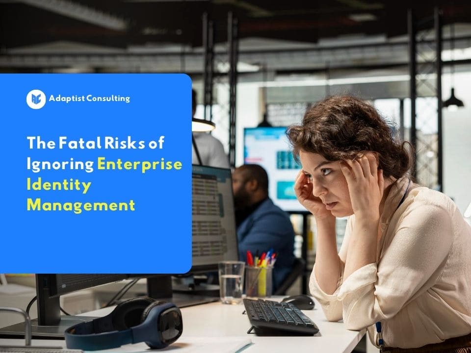 Stressed office worker woman at a computer as an illustration of the fatal risks from ignoring enterprise identity management.