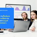 Employee is analyzing customer retention charts and churn rate metrics on a system dashboard on a computer monitor screen.