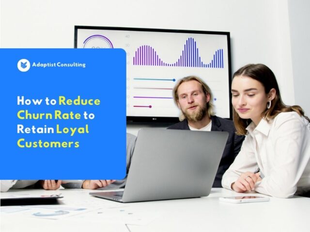 Employee is analyzing customer retention charts and churn rate metrics on a system dashboard on a computer monitor screen.