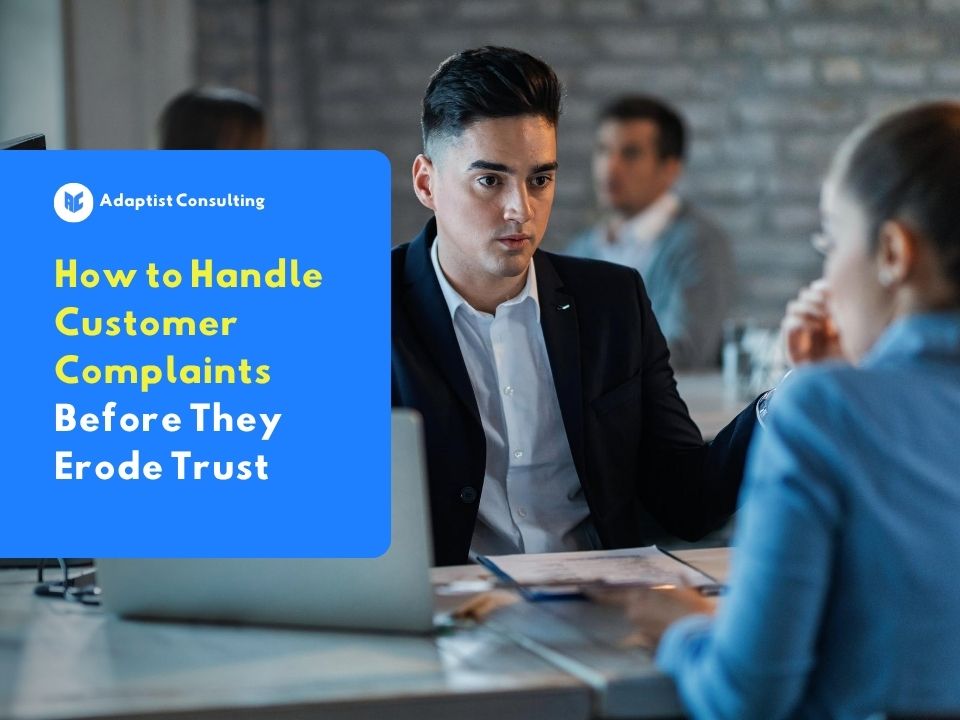 Illustration of a customer service representative speaking with a customer in an office about handling customer complaints to maintain trust.