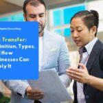 Two professionals reviewing a risk analysis document together, illustrating the process of evaluating and planning a risk transfer strategy within a business risk management framework.