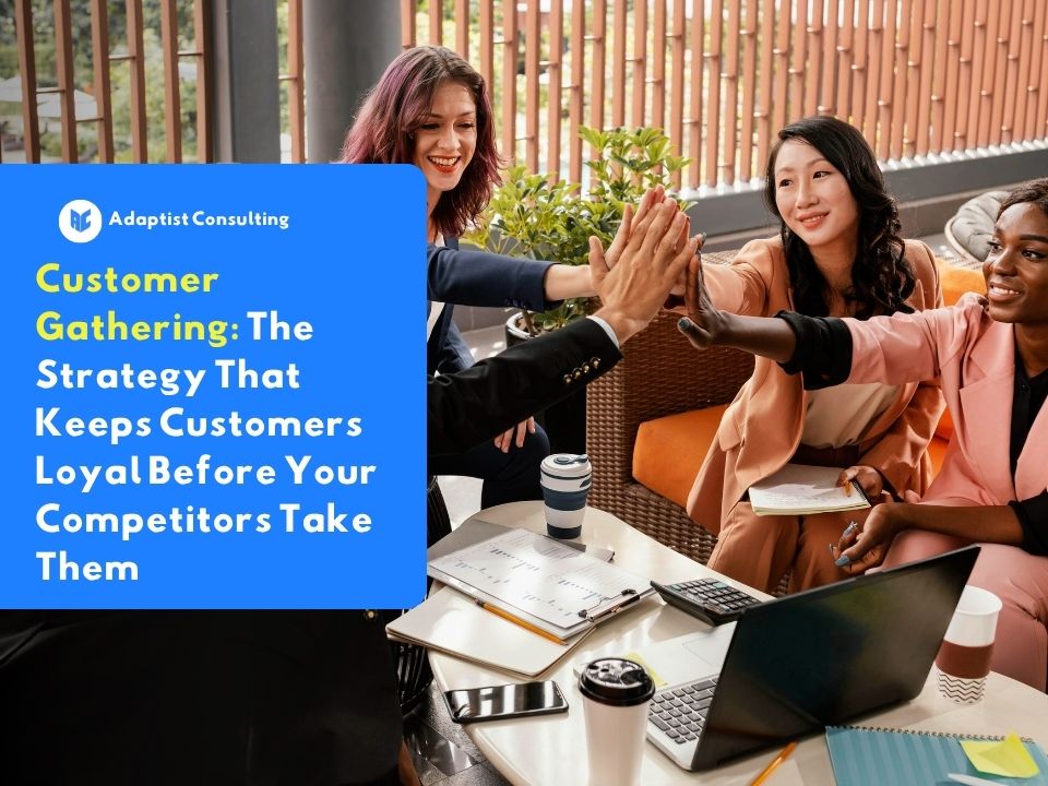 A group of professionals joining hands together in a team huddle during a customer gathering event.