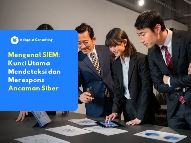 Tim profesional sedang berdiskusi menganalisis data keamanan pada tablet, mengilustrasikan pentingnya mengenal SIEM sebagai kunci utama mendeteksi dan merespons ancaman siber perusahaan.