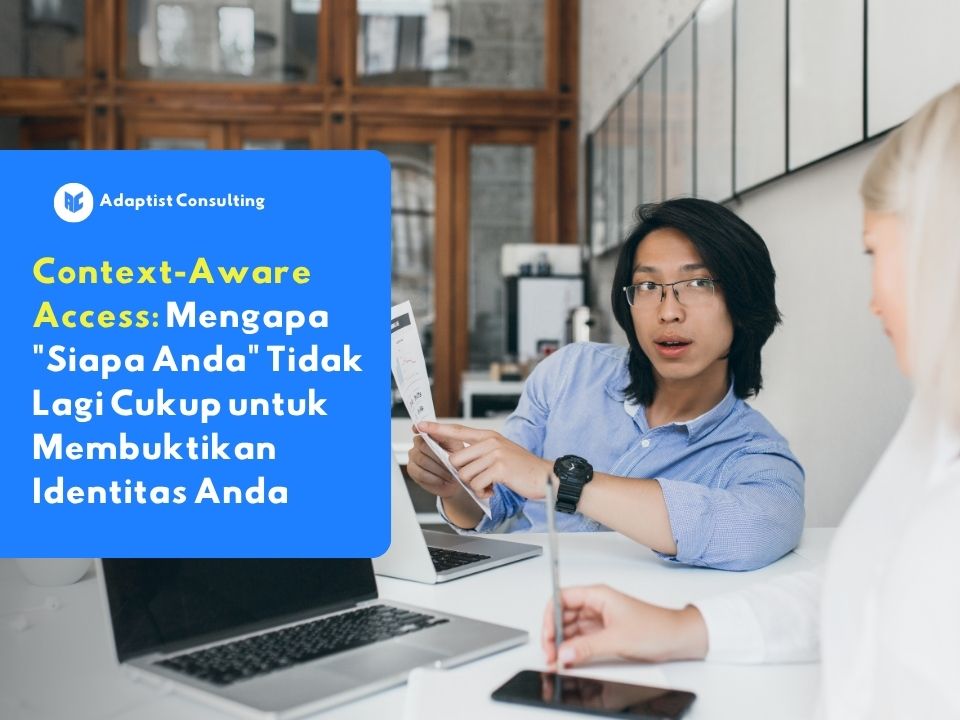 Dua profesional berdiskusi tentang keamanan akses sistem di ruang kerja modern, menggambarkan pentingnya context-aware access dalam melindungi data perusahaan.