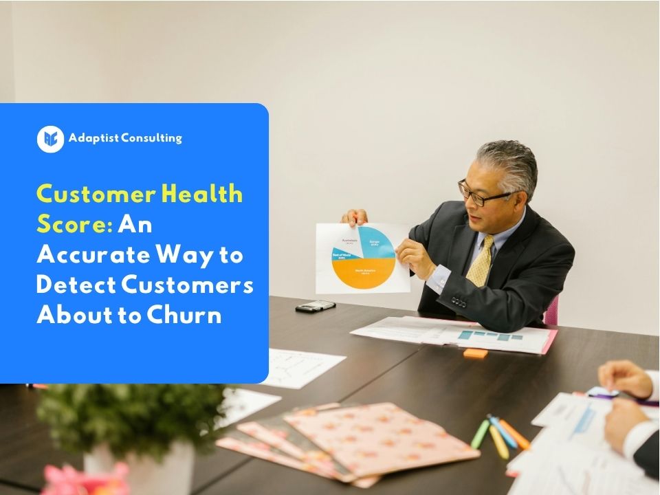 An employee is analyzing a client retention graph on a monitor screen to evaluate the company's Customer Health Score matrix.