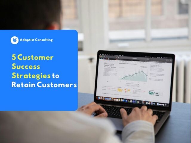 Employees analyzing customer retention metrics dashboards and discussing B2B customer success strategies in a meeting room