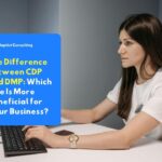 Employees comparing CDP and DMP system architectures through a dashboard screen for enterprise data management strategies.