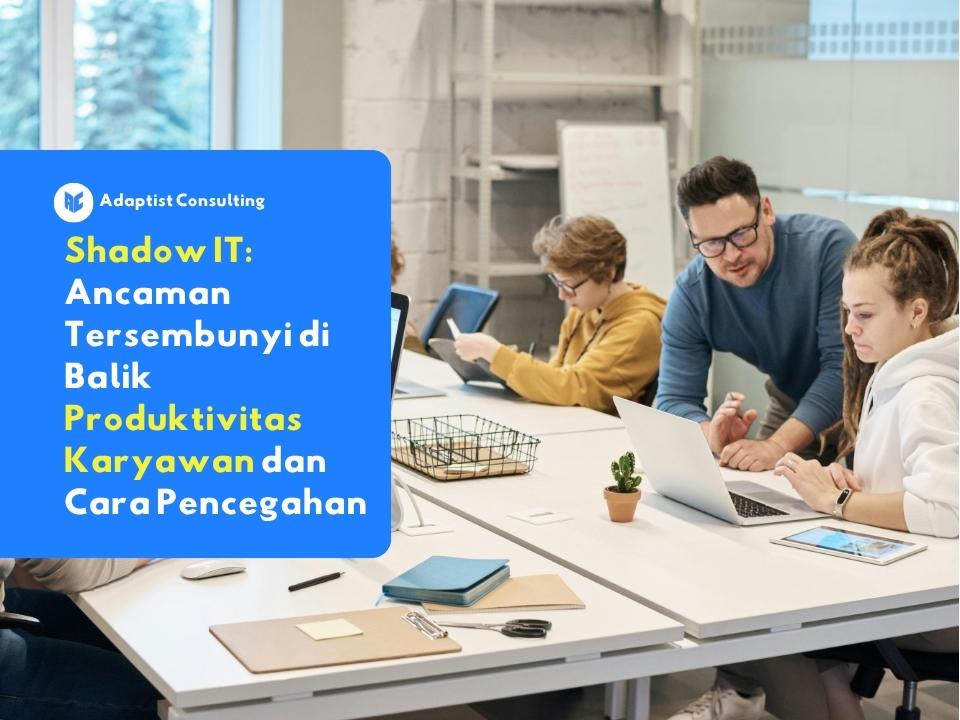 Sekelompok karyawan yang sedang sibuk bekerja menggunakan laptop dan perangkat pribadi di meja kantor, mengilustrasikan potensi terjadinya praktik shadow it.