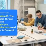 A group of employees busy working on laptops and personal devices at their office desks illustrates the potential for shadow IT practices.